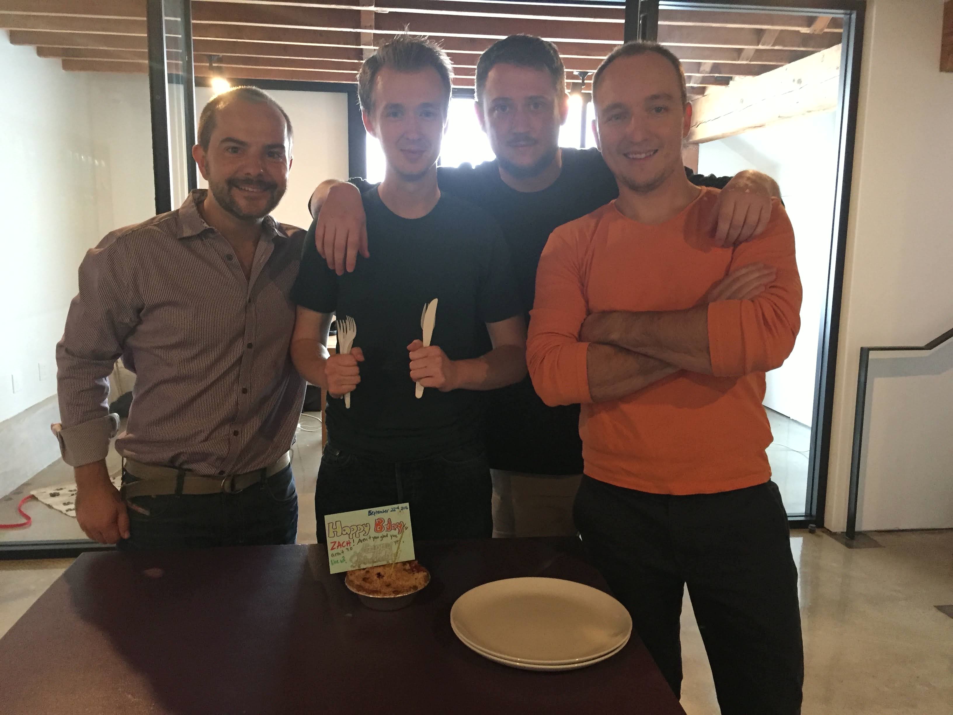Four members of the founding Empower team standing together in the company's first office.